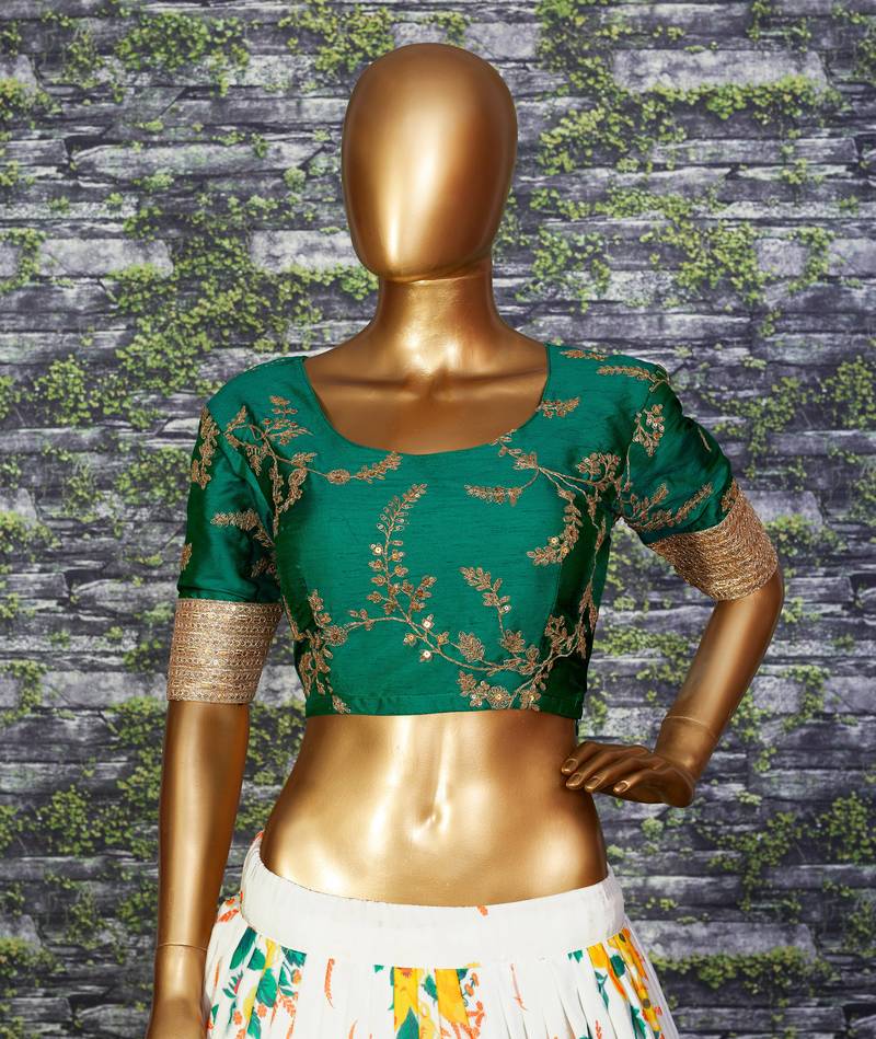 Engrossing Cream Floral Designer Lehenga with rich embroidered Green Blouse and Dupatta