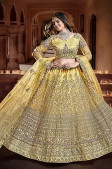 Delightful Yellow Zari, Sequins and thread Embroidered net semi stitched lehenga