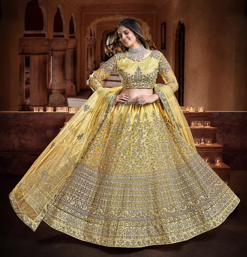 Delightful Yellow Zari, Sequins and thread Embroidered net semi stitched lehenga