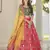 Red, green and yellow colored thread and sequins embroidered silk semi stitched lehenga