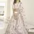 White thread and sequins embroidered silk semi stitched lehenga