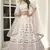 White thread and sequins embroidered silk semi stitched lehenga