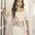 White thread and sequins embroidered silk semi stitched lehenga