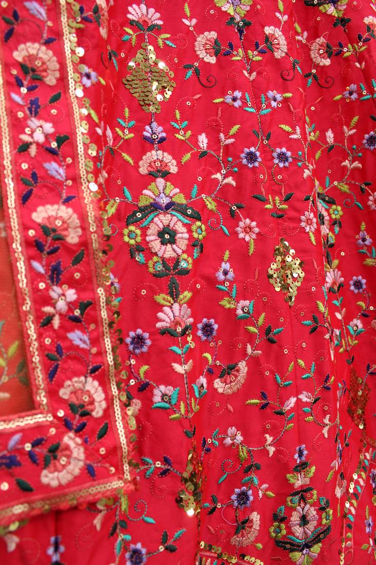 Red, green and yellow colored thread and sequins embroidered silk semi stitched lehenga