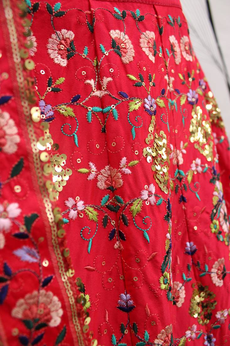 Red, green and yellow colored thread and sequins embroidered silk semi stitched lehenga