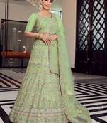 Mesmerizing pista green colored mirror, zari, zarkan, and thread embroidered organza wedding & Party Lehenga