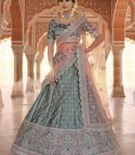 Desirable Rama Green Zarkan, Dori, and Thread embroidered satin Bridal Lehenga
