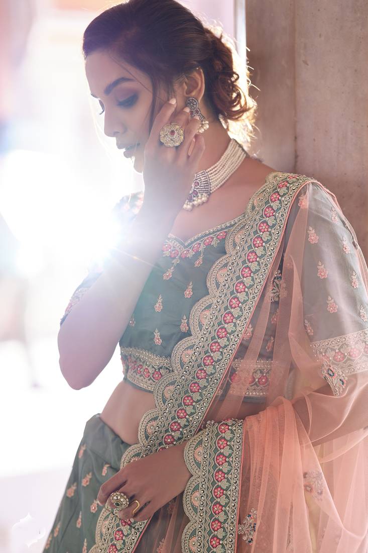 Desirable Rama Green Zarkan, Dori, and Thread embroidered satin Bridal Lehenga