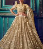 Awesome Dusky Beige Color Soft Net Semi Stitched Lehenga Choli with Sequins & Ruffle Work