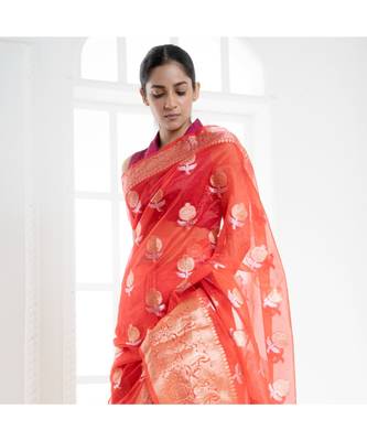 Fire orange organza silk saree with zari border and silver golden floral motifs 1