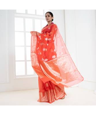 Fire orange organza silk saree with zari border and silver golden floral motifs 3