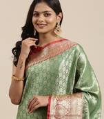 Green woven kanchipuram silk blend saree with blouse