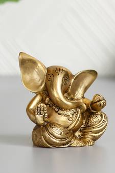 brass ganesha idol with modak