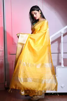 This is   Yellow Blended Silk saree with temple border from Charukriti