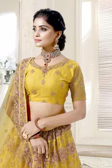 Fetching Mustard Yellow Dori And Thread Embroidered With Diamond Work Bridal Net Semi Stitched Lehenga Choli