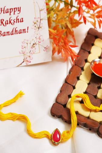 Red Gold Tone Kundan Rakhi With Yellow Thread