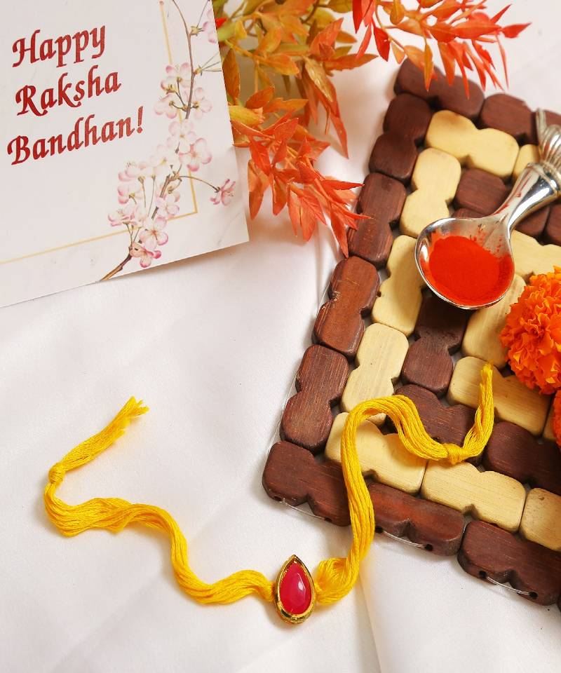 Red Gold Tone Kundan Rakhi With Yellow Thread