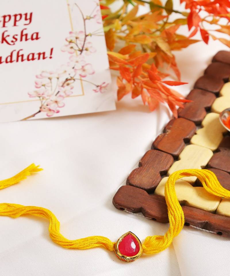 Red Gold Tone Kundan Rakhi With Yellow Thread