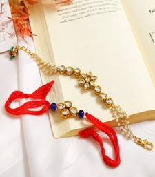 Gold-Toned Kundan Embellished Rakhi & Floral Lumba Set Of 2 
