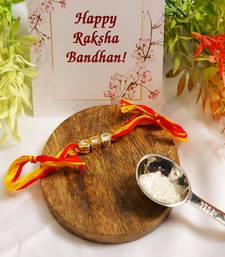 Gold Tone Kundan Rakhi With Red Yellow Cotton Thread