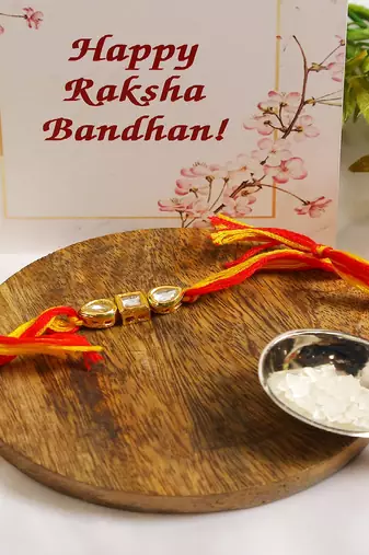 Gold Tone Kundan Rakhi With Red Yellow Cotton Thread