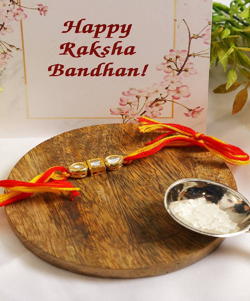 Gold Tone Kundan Rakhi With Red Yellow Cotton Thread