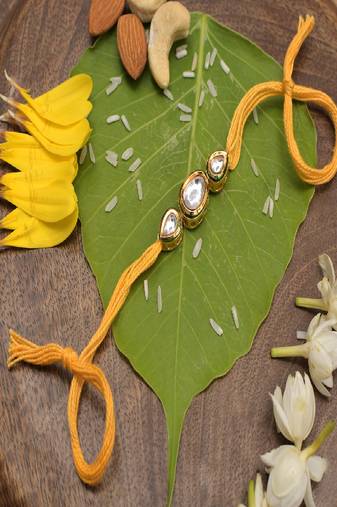 Gold Tone Kundan Rakhi With Yellow Cotton Thread