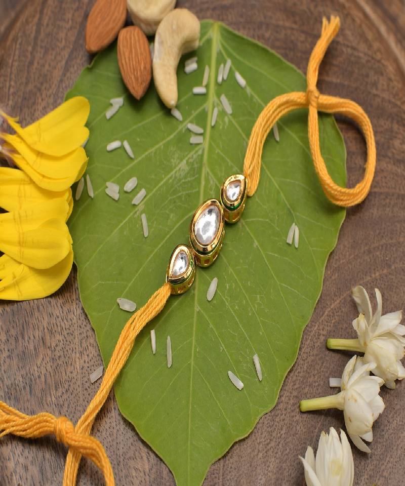 Gold Tone Kundan Rakhi With Yellow Cotton Thread