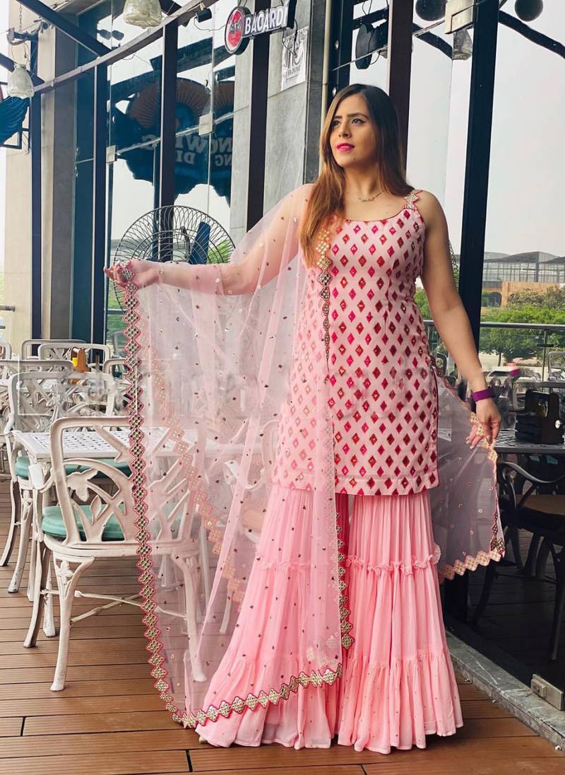 Captivating Baby Pink Faux Georgette multi layered party wear Sharara suit