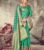 Dark green woven silk saree with blouse