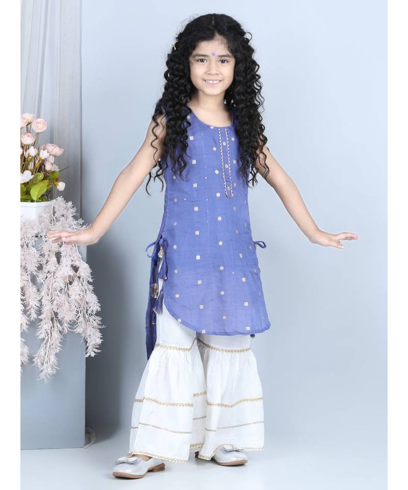 Purple gold jacquard printed kurti with tassles work paired with offwhite Sharara