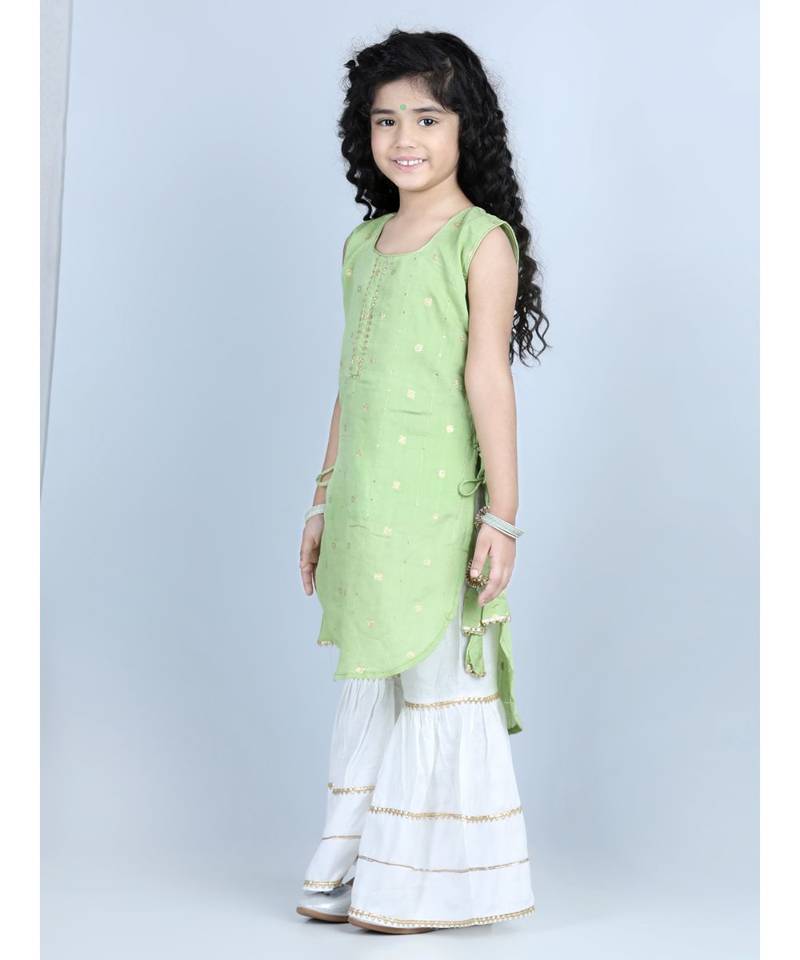 Green gold jacquard printed kurti with tassles work paired with offwhite Sharara
