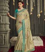 Beige embroidered pure silk saree with blouse
