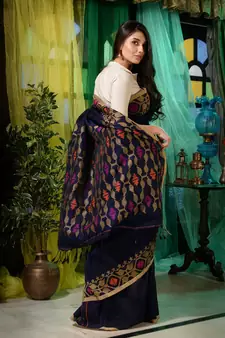 Look dainty and charming in this navy blue linen handwoven saree. It has small motifs woven all over.