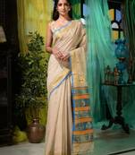 Ethnic patterns with modern colour combinations are reflected in this beige cotton hand spun handwoven saree.