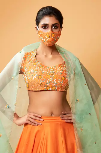 Bright Orange Lehenga With Intricate Handwork 