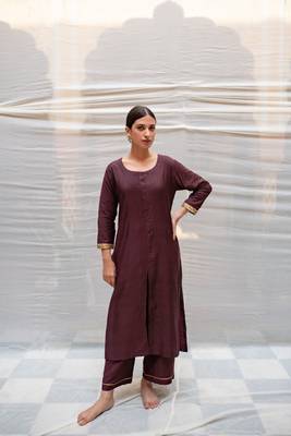 Brown cotton silk straight kurta with hand embroidered sequin zardozi border on sleeves .The kurta is paired with pants. 1