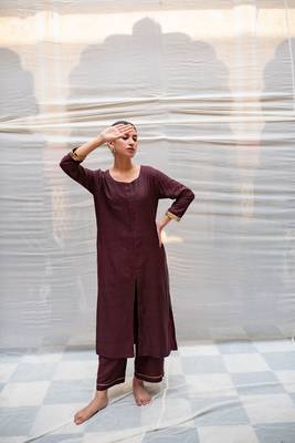 Brown cotton silk straight kurta with hand embroidered sequin zardozi border on sleeves .The kurta is paired with pants. 2