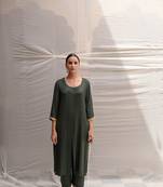 Green cotton straight kurta with herringbone weave  highlighted with hand embroidered sequin zardozi border on sleeves.