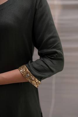 Green cotton straight kurta with herringbone weave  highlighted with hand embroidered sequin zardozi border on sleeves. 5