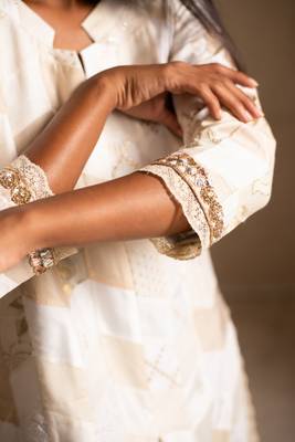 Upcycled patchwork kurta in shades of ivory and beige made with remnants of heritage fabrics like silks,cottons,prints. 5