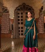 Teal chanderi silk lehanga with upcycled patchwork detail in shades of pink made with remnants of heritage fabrics.
