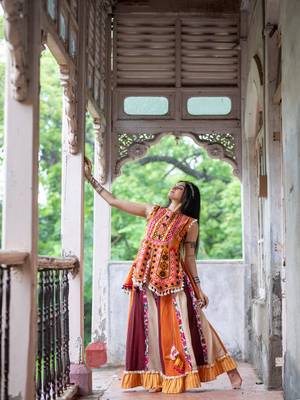 Eye catchy organge embroidered peplum style top with colorfull flairy skirt 1