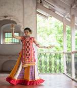 Red circular treditional embroidered panel top paired with multicolor flairy skirt