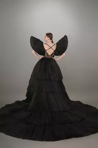 Black Embroidered Mini Dress With Pleated Power Shoulder And A Detachable Layered Pleated Trail