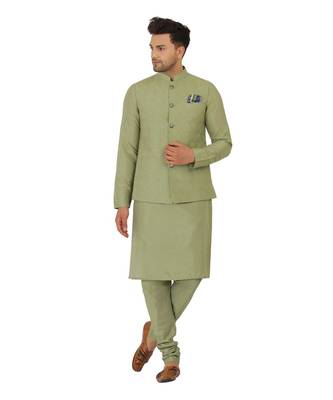 Nehru jacket in cotton silk base. It is paired with a matching kurta and a churidar pyjama. 1