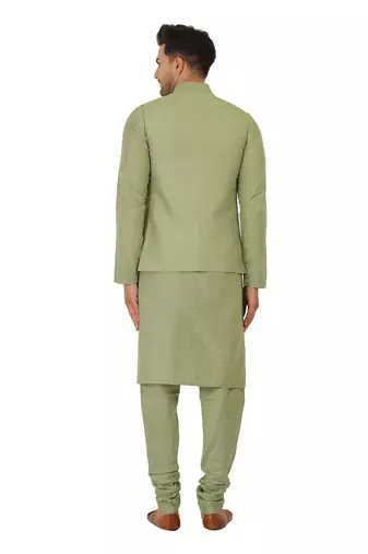 Nehru jacket in cotton silk base. It is paired with a matching kurta and a churidar pyjama.