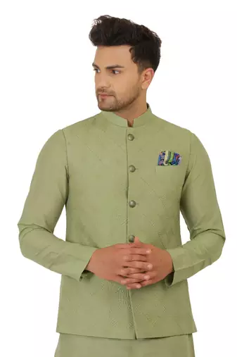 Nehru jacket in cotton silk base. It is paired with a matching kurta and a churidar pyjama.