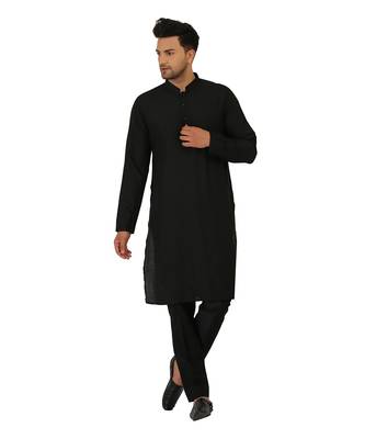 Featuring a black Quiled nehru jacket in art silk base. It is paired with a matching kurta and pants in ruby silk base. 1