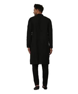 Featuring a black Quiled nehru jacket in art silk base. It is paired with a matching kurta and pants in ruby silk base. 3